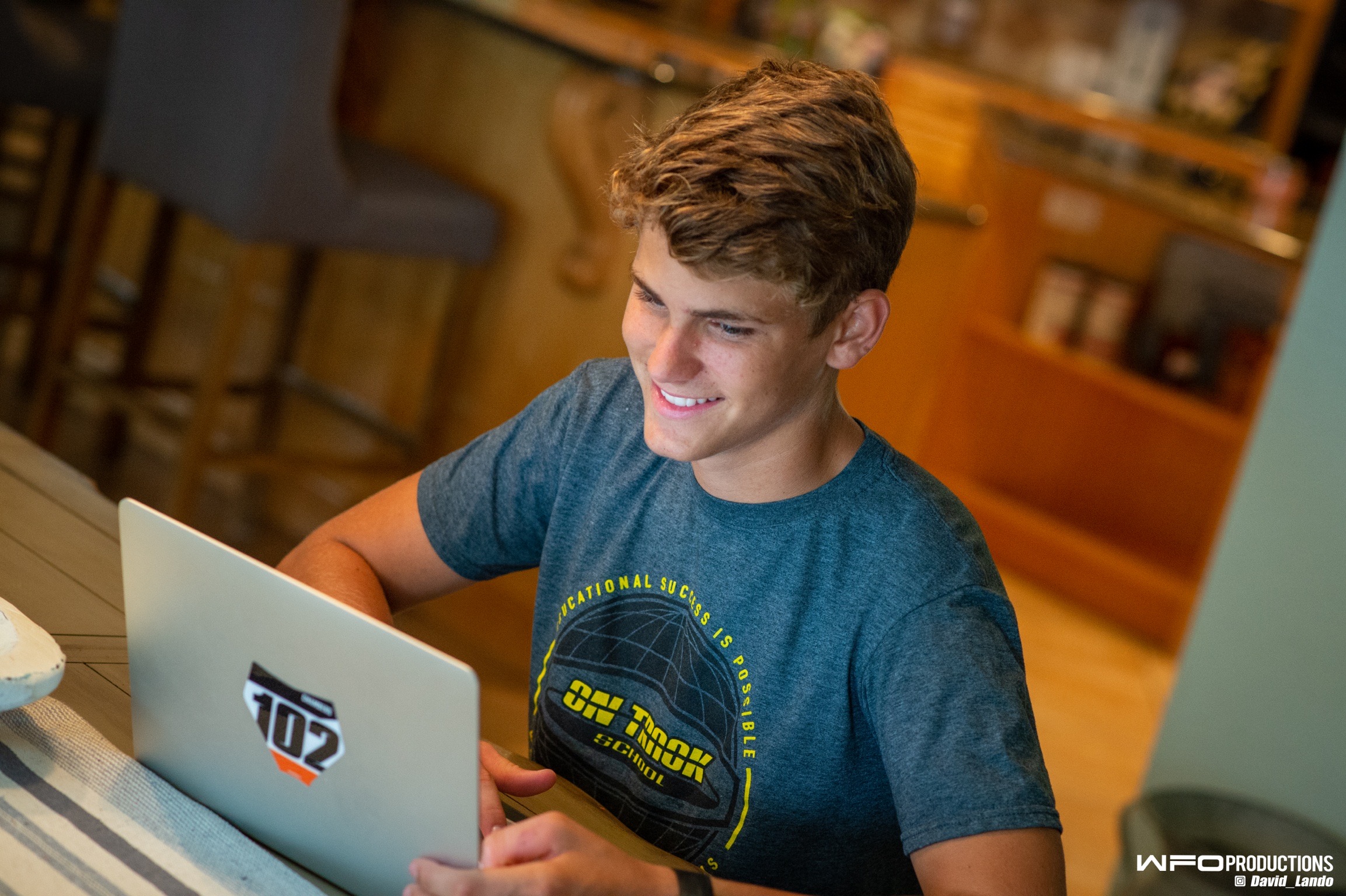 Male high school student sitting at a laptop for the does dual enrollment count as attending college blog.